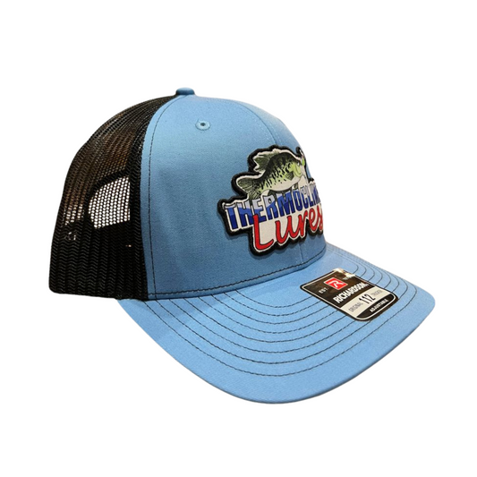 Right side view of the Thermocline Lures Columbia Blue and Black Richardson 112 Trucker Hat, showcasing its bright blue front and black mesh back.