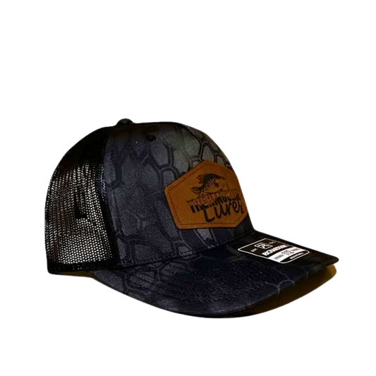 Right side view of the Thermocline Lures Kryptek Typhon/Black Trucker Hat, with a leather patch logo, black hexagonal camo front, and breathable black mesh back.