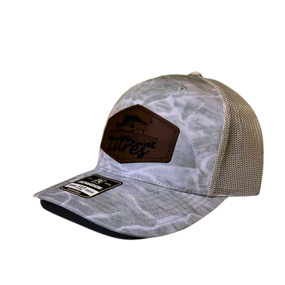 Side view of the Thermocline Lures gray Mossy Oak Break-Up Infinity camo trucker hat with a brown leather patch logo and adjustable mesh back for fishing enthusiasts.