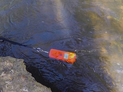 The Button Digital Fish Counter floating on the water, showcasing its waterproof and buoyant design, ensuring durability and reliability for fishing adventures.